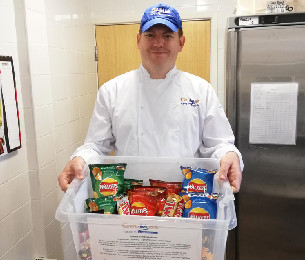 Snak-Pak service CRUMBS worker carrying Snak-Pak products
