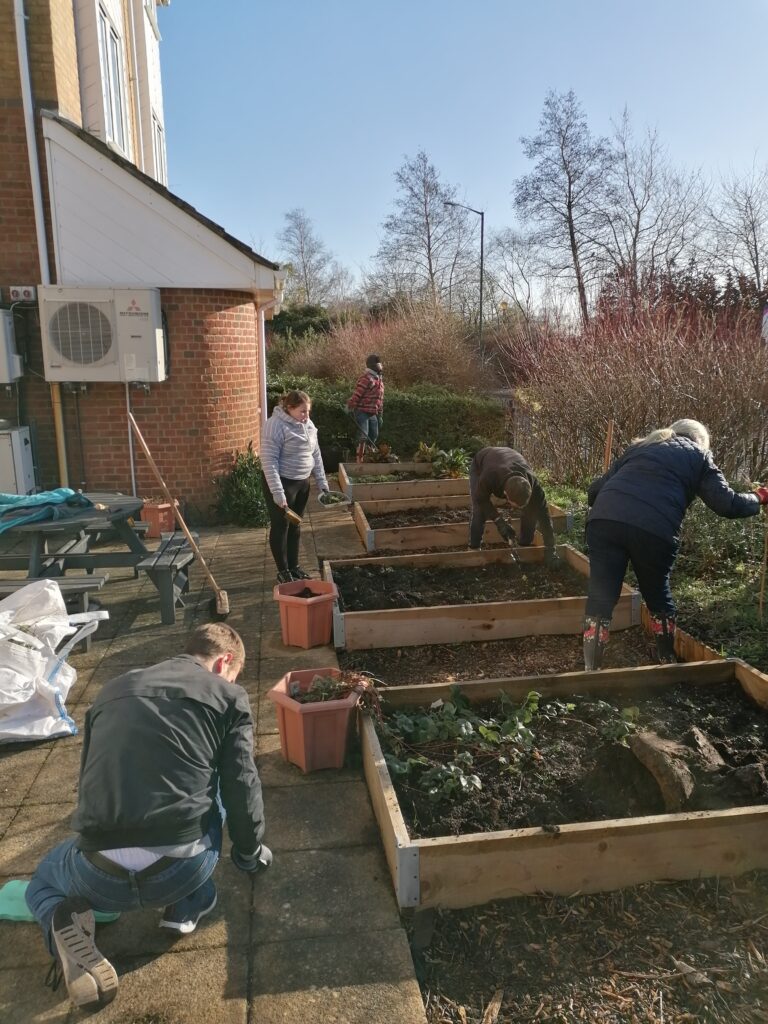 B&Q volunteers and CRUMBS trainees work together in the Community Kitchen Garden outside CRUMBS' training centre in Bournemouth. 