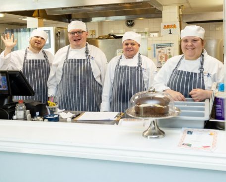 A group of trainees in the training kitchen