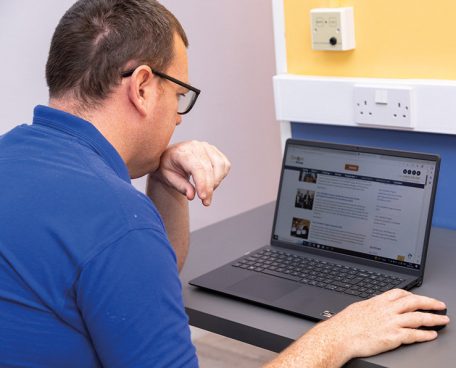 A trainee at a laptop computer