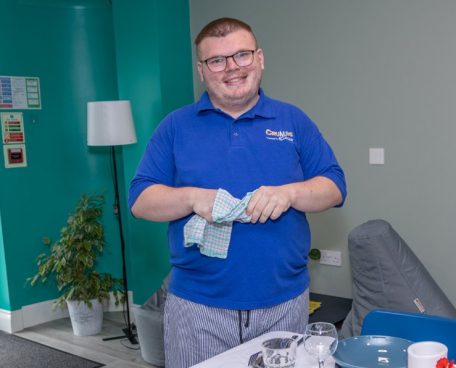 A trainee in a polo shirt in the dining room