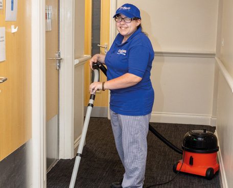 A trainee vacuuming