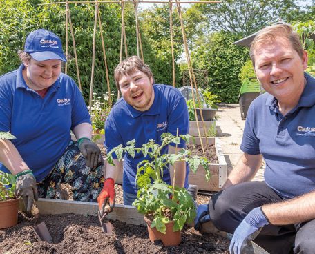 Two trainees and trainer in the kitchen garden